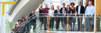 An indoor image of the KBHN Board, research presenters and staff team, standing on the staircase at SFU’s Morris J. Wosk Centre for Dialogue on Research Day