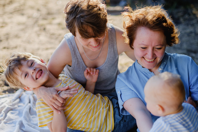 A family of four enjoys a sunny day at the beach.
