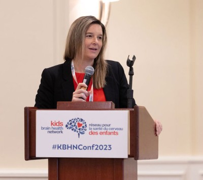 Dr. Jennifer Zwicker is speaking at the podium at the Annual KBHN Conference in 2023.