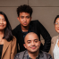 A diverse group of six people in professional attire pose confidently against a neutral office background. They convey a sense of teamwork and positivity.